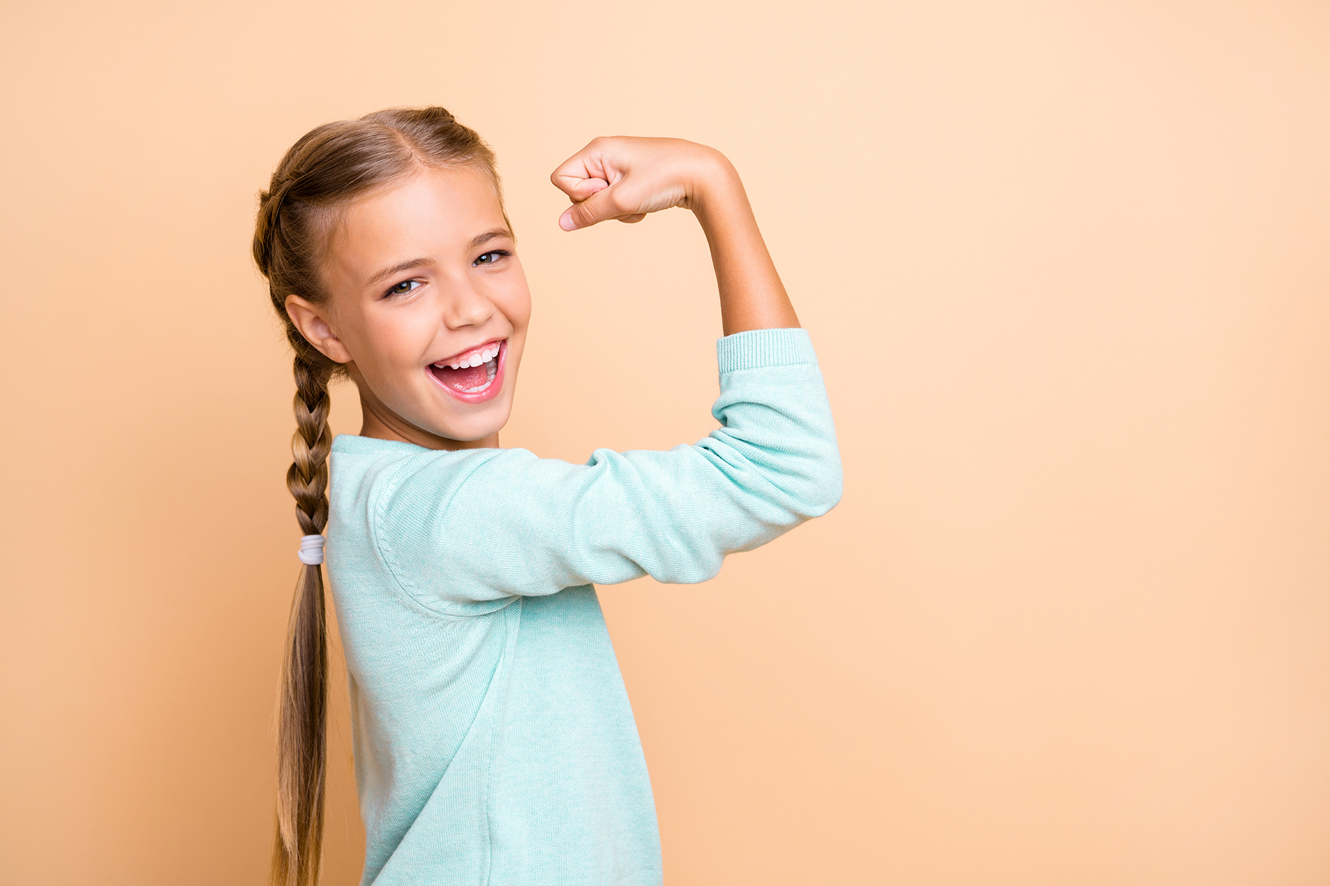 Profile photo of beautiful excited little lady ambitious person raise fist celebrating successful training workout wear blue pullover isolated beige pastel color background